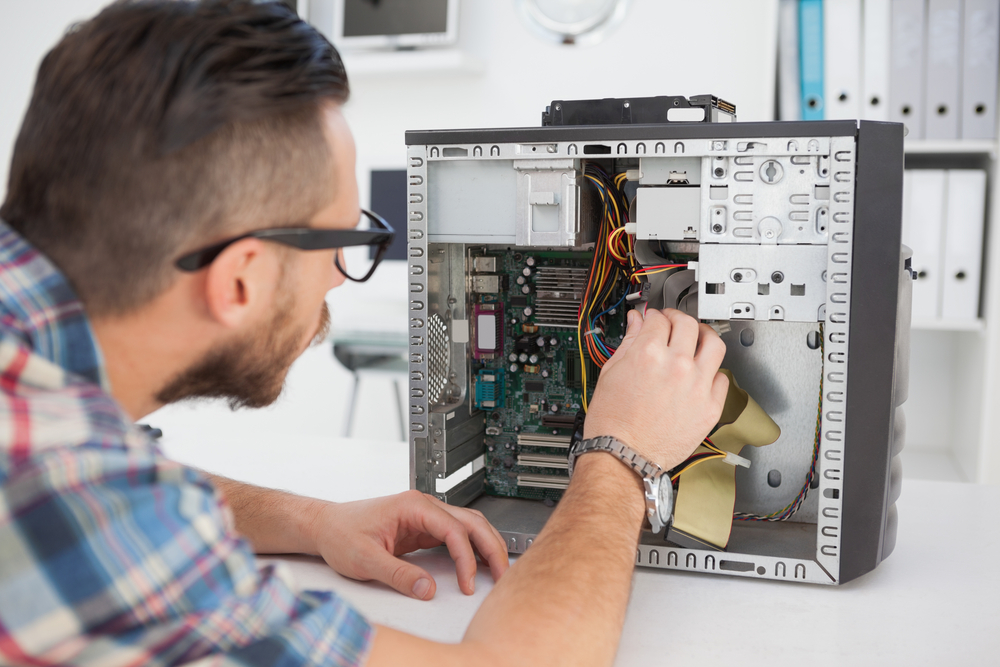 Computer engineer working on broken console in his office-1