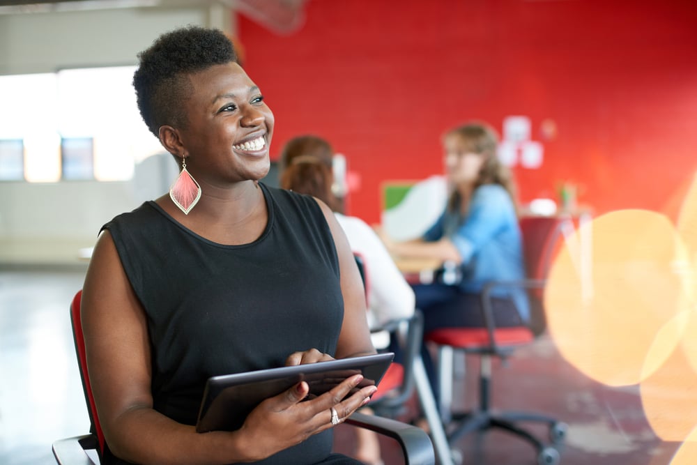 Confident female designer working on a digital tablet in red creative office space-Mar-28-2024-03-36-17-4487-PM