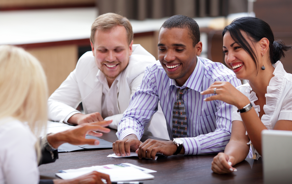 Happy business people sitting around the table at the meeting-1