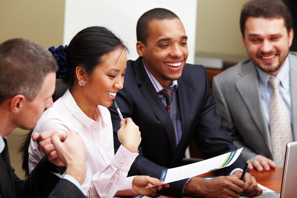 Multi ethnic business team at a meeting. Interacting. Focus on woman-1