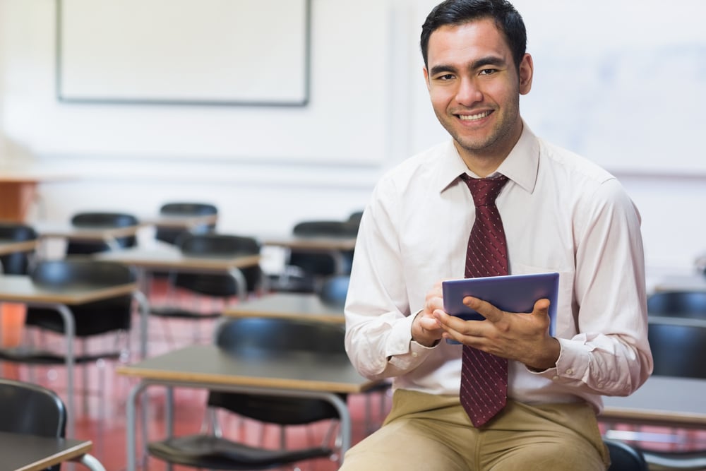 Portrait of a smiling teacher with tablet PC in the class room