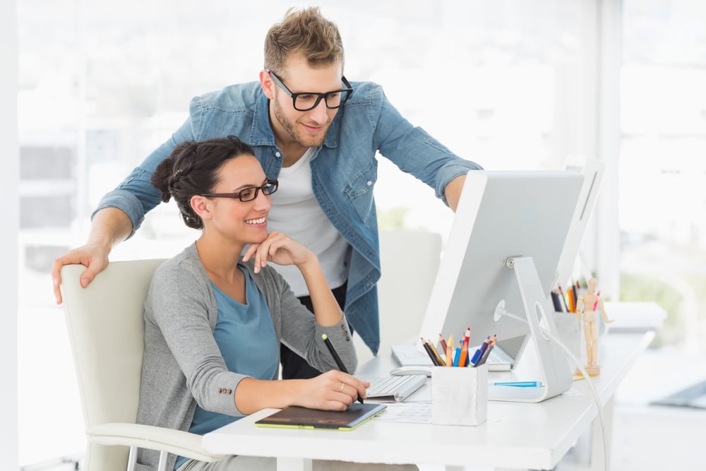 Young design team working at desk in creative office