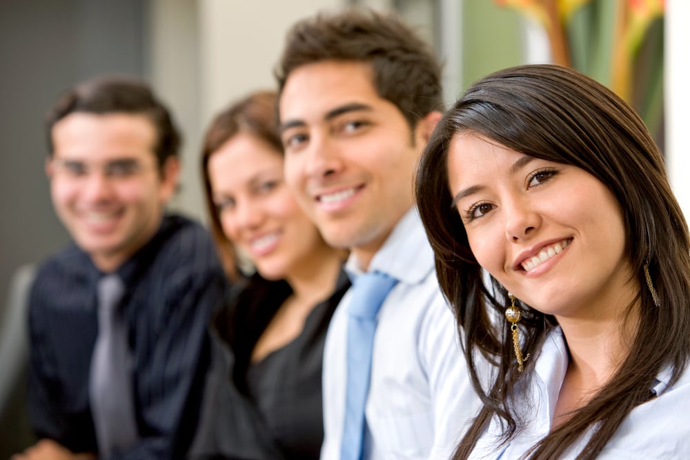 businesswoman and business team in an office smiling